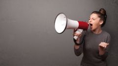 A girl shouting into a megaphone.