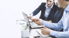 This image shows a business team working together at a desk.