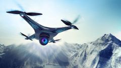 This image shows a flying drone in front of the mountains. 
