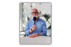 A picture of Thomas holding the microphone.