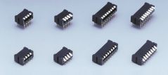 Eight DIP switches in different sizes on grey background.